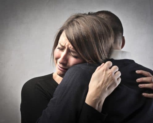 Sad wife hugs her husband