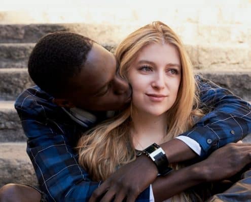 man hugging and kissing woman