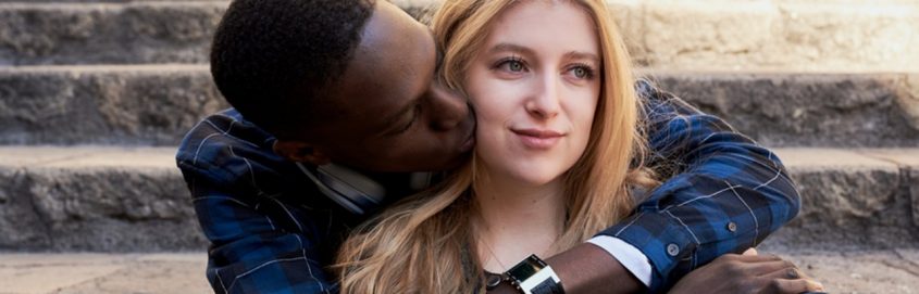 man hugging and kissing woman