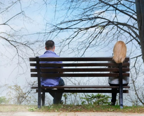 couple-on-bench-far-apart